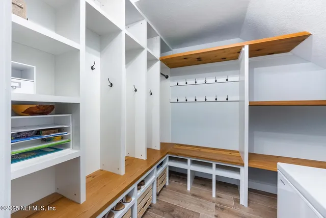 a bathroom with a granite countertop sink a mirror and a toilet