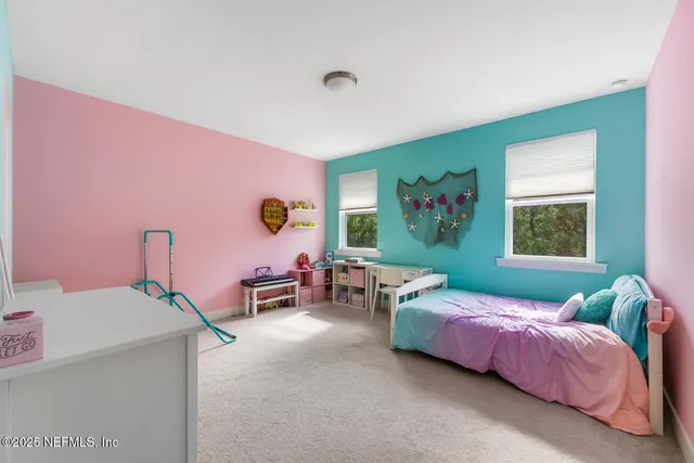 a bedroom with bed and a window