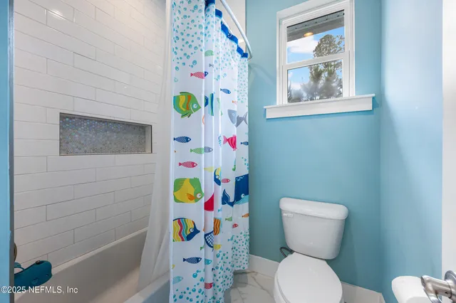 a view of a house with a backyard porch and sitting area