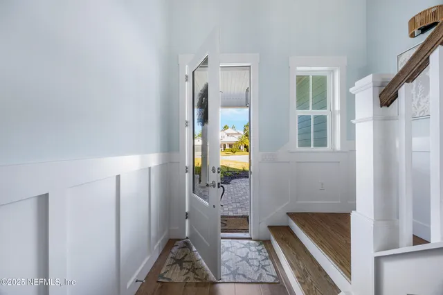 a view of entryway and hall with wooden floor