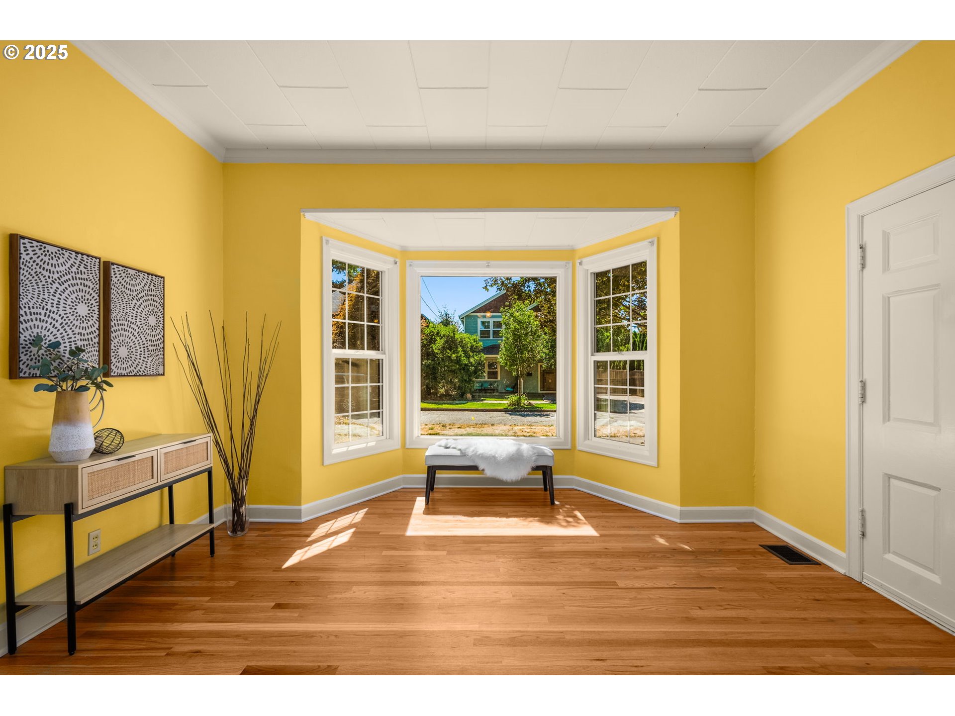 1127 Southeast Sherrett Street Portland, OR 97202 - Photo 11 of 37 a view of an empty room with wooden floor and a window