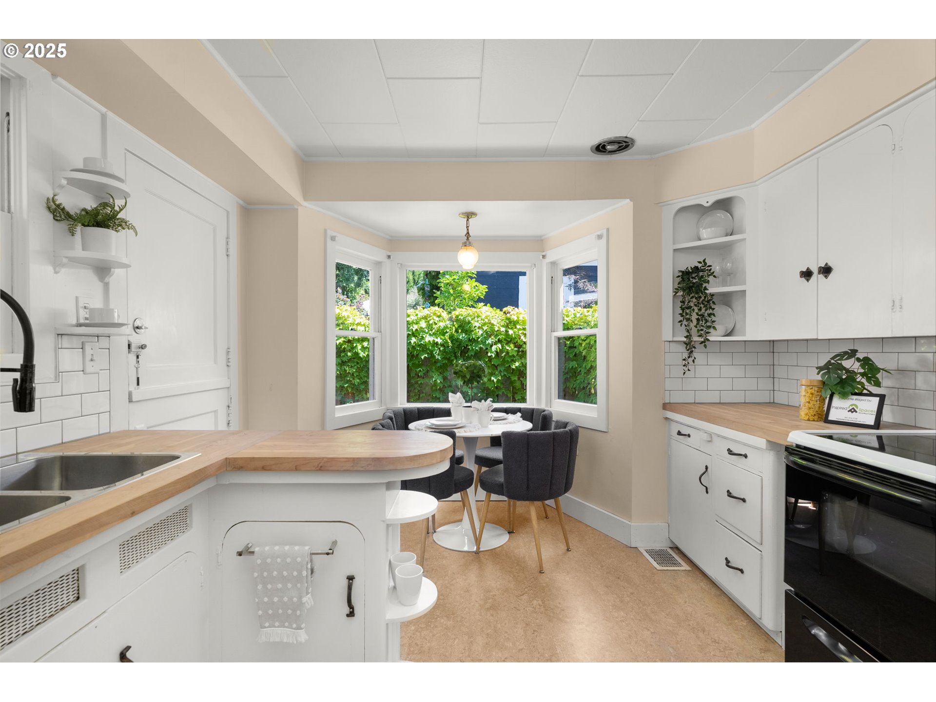 1127 Southeast Sherrett Street Portland, OR 97202 - Photo 15 of 37 a kitchen with a sink stove and cabinets