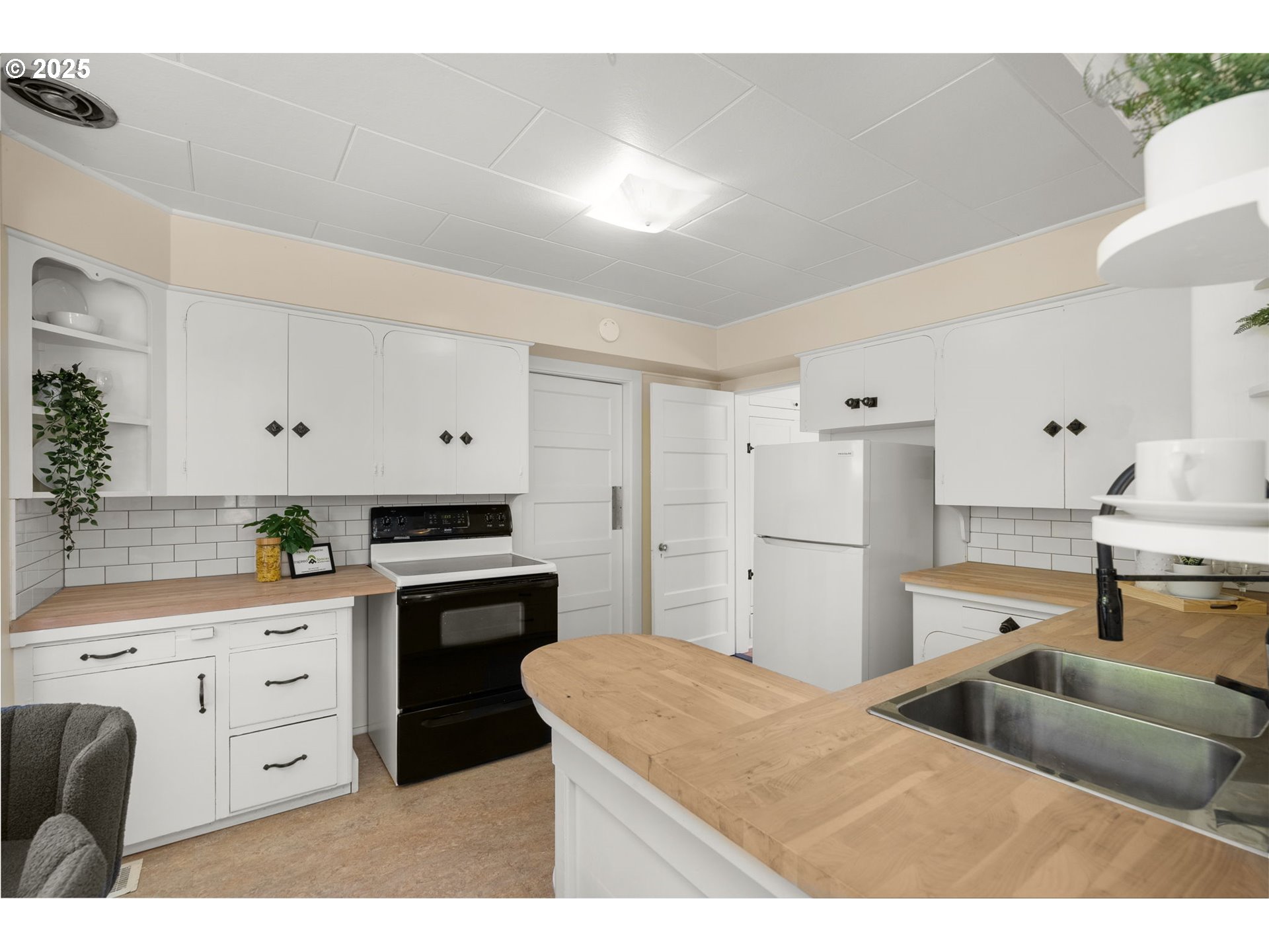 1127 Southeast Sherrett Street Portland, OR 97202 - Photo 16 of 37 a kitchen with cabinets and white appliances