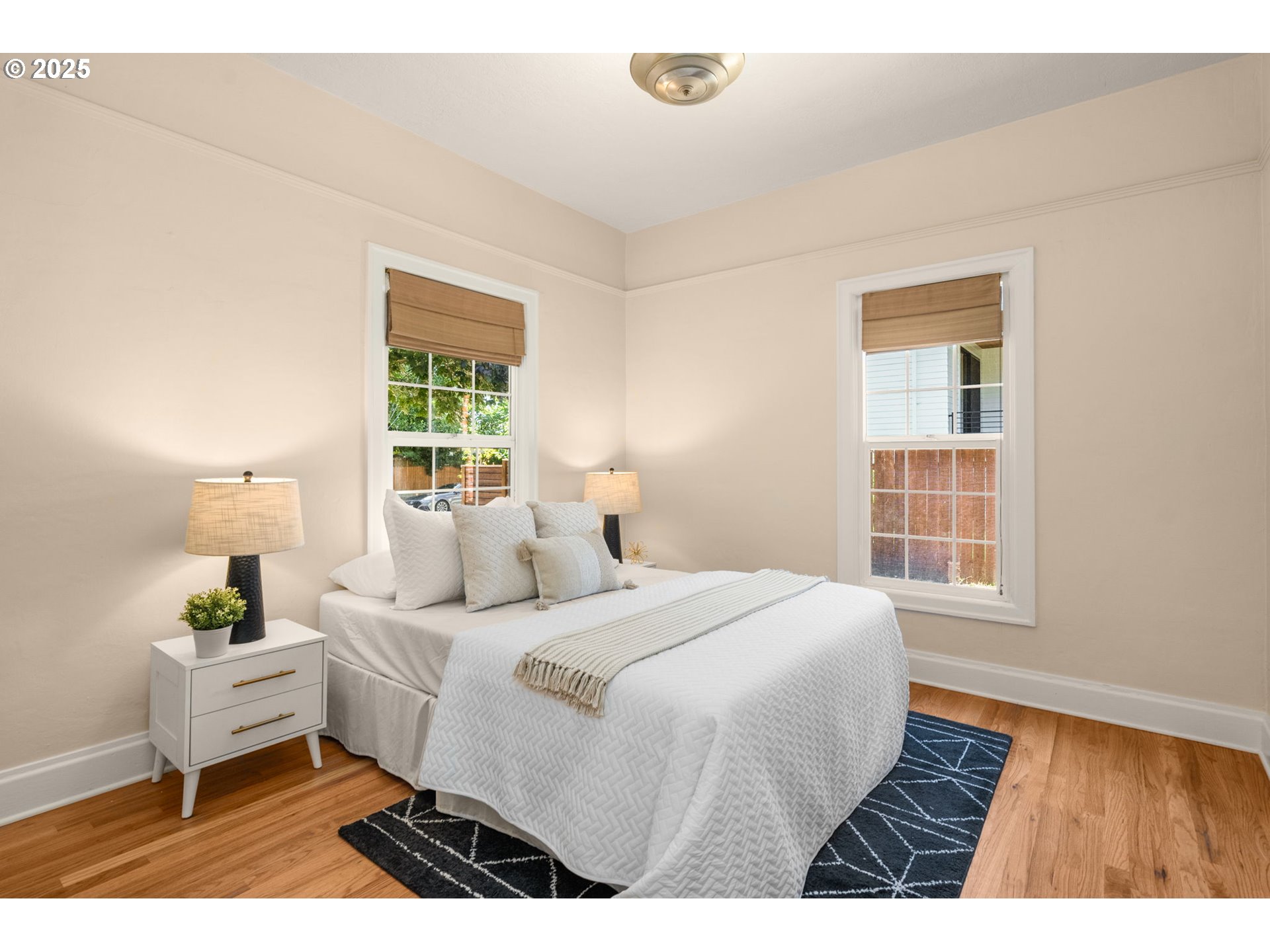 1127 Southeast Sherrett Street Portland, OR 97202 - Photo 17 of 37 a bedroom with a bed and a window