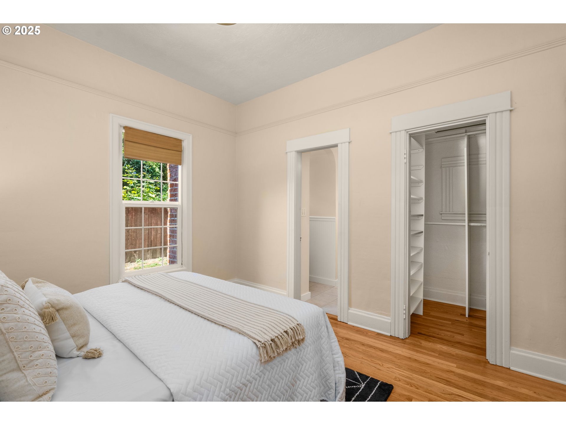 1127 Southeast Sherrett Street Portland, OR 97202 - Photo 18 of 37 a bedroom with a bed and a window