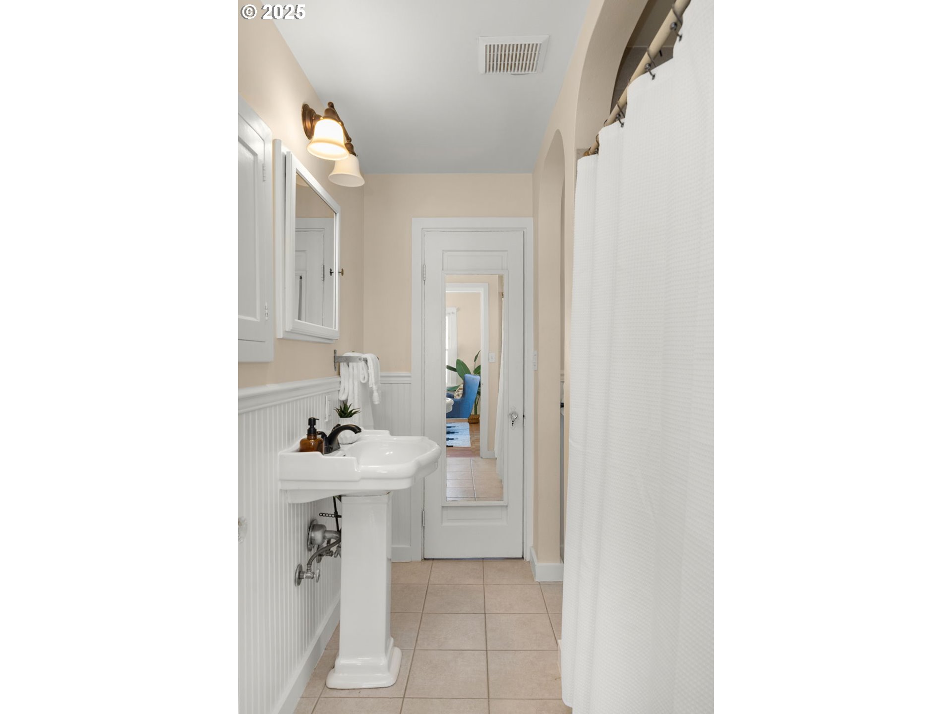 1127 Southeast Sherrett Street Portland, OR 97202 - Photo 19 of 37 a bathroom with a sink a toilet and mirror