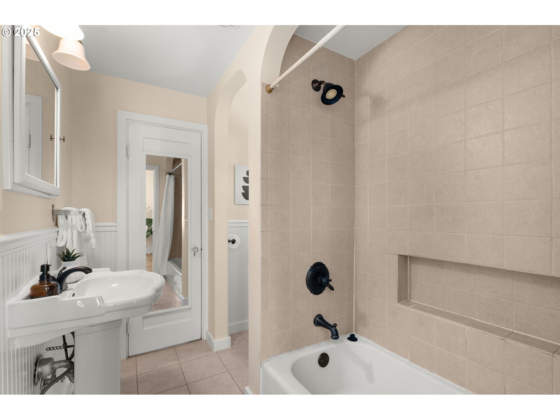 1127 Southeast Sherrett Street Portland, OR 97202 - Photo 20 of 37 a bathroom with a sink a mirror and shower