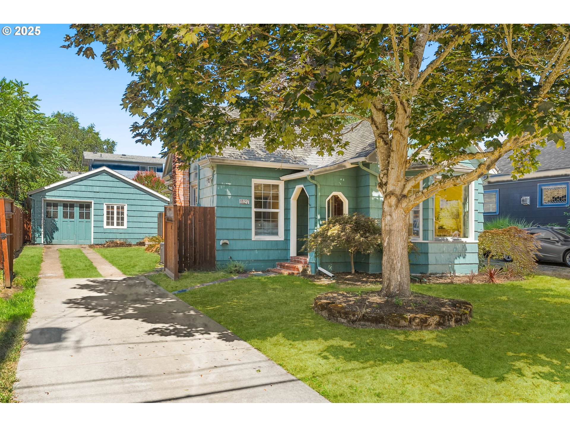 1127 Southeast Sherrett Street Portland, OR 97202 - Photo 2 of 37 a front view of a house with a yard