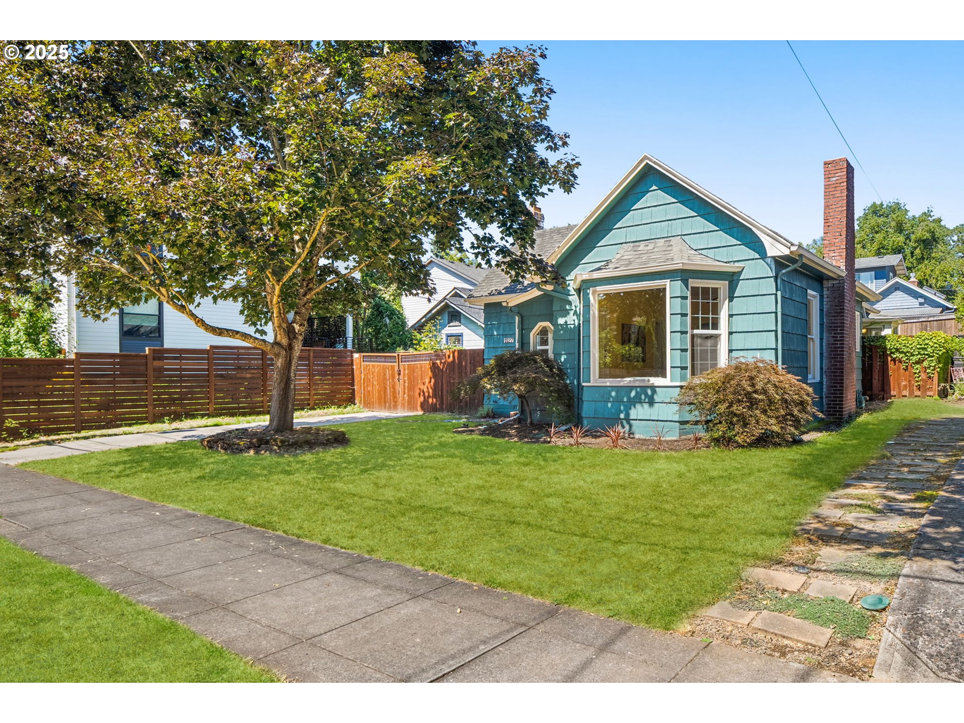 1127 Southeast Sherrett Street Portland, OR 97202 - Photo 3 of 37 a front view of a house with a yard