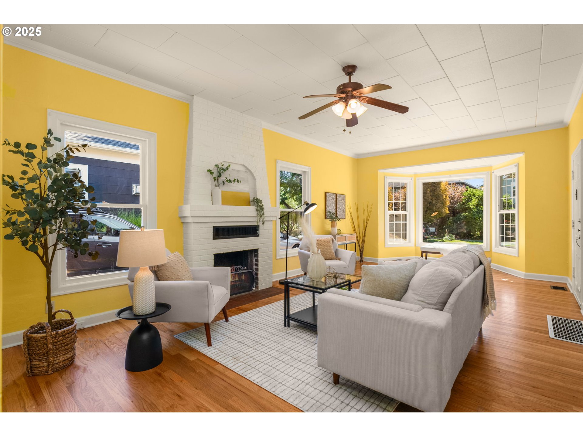 1127 Southeast Sherrett Street Portland, OR 97202 - Photo 8 of 37 a living room with furniture a chandelier and a floor to ceiling window