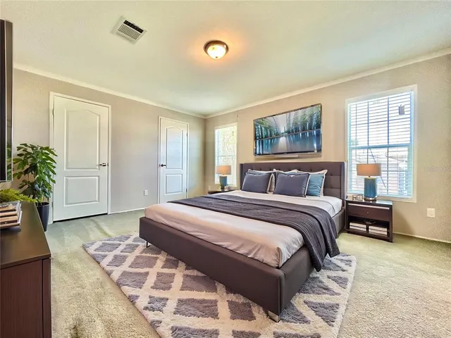 a bedroom with a large bed and a window