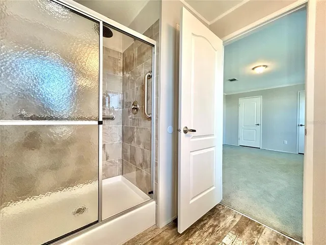 a bathroom with a glass shower door
