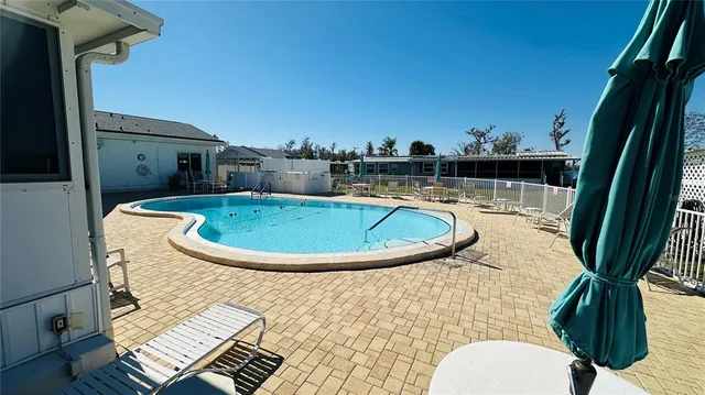 a view of a swimming pool with a lounge chair