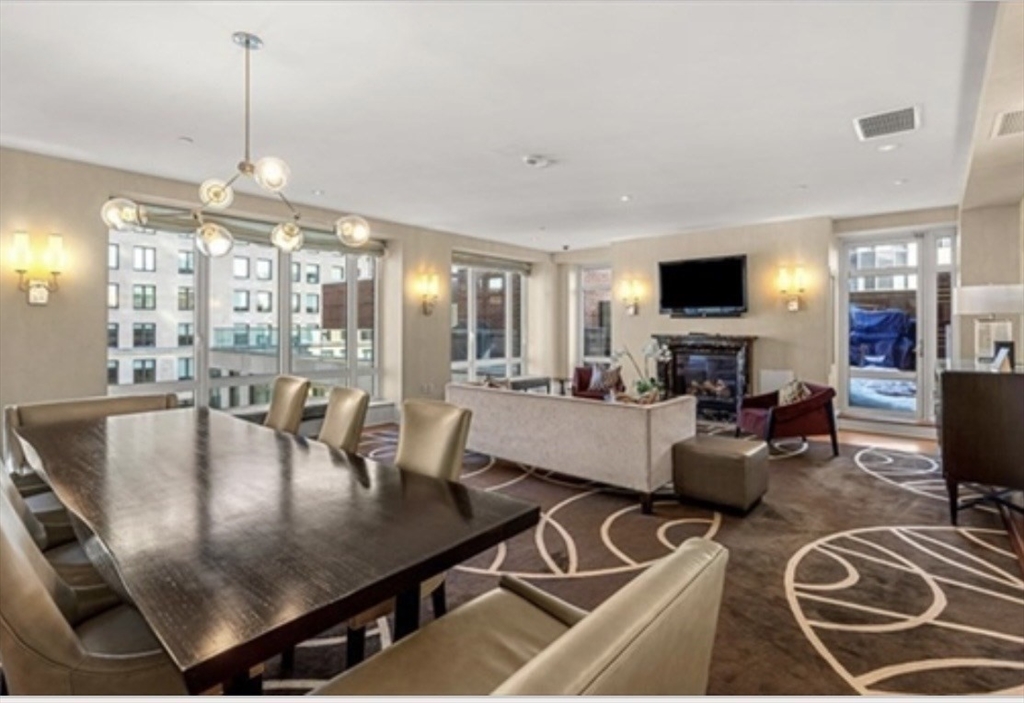 400 Stuart Street, Unit 18G Boston, MA 02116 - Photo 19 of 20 a living room with furniture and a chandelier