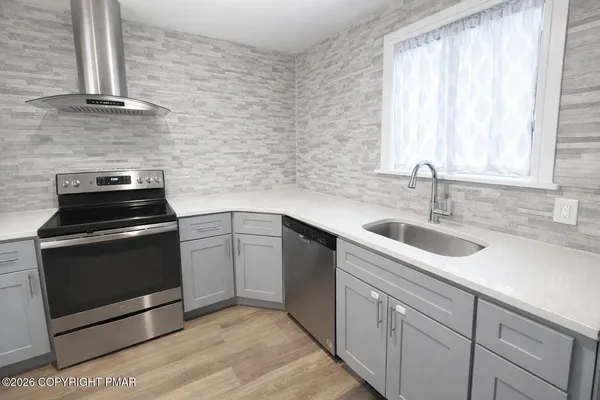 a kitchen with a sink stove and cabinets