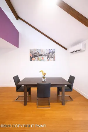 a view of a dining room with furniture and a chandelier