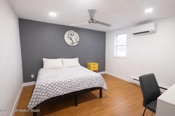 a bedroom with a bed and a chandelier