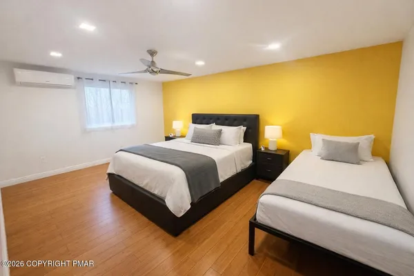a bedroom with bed and a night stand