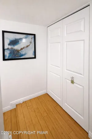 a view of an empty room with wooden floor