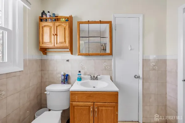 a bathroom with a sink toilet and mirror