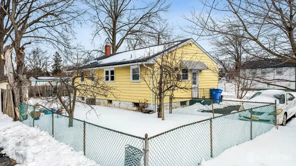 a view of a house with large trees