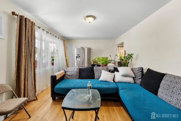 a living room with furniture potted plant and a window