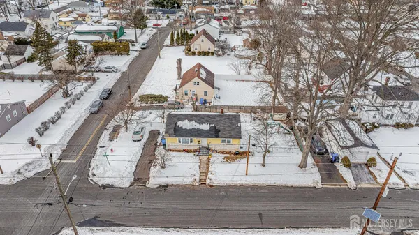 an aerial view of a large building with table and chairs