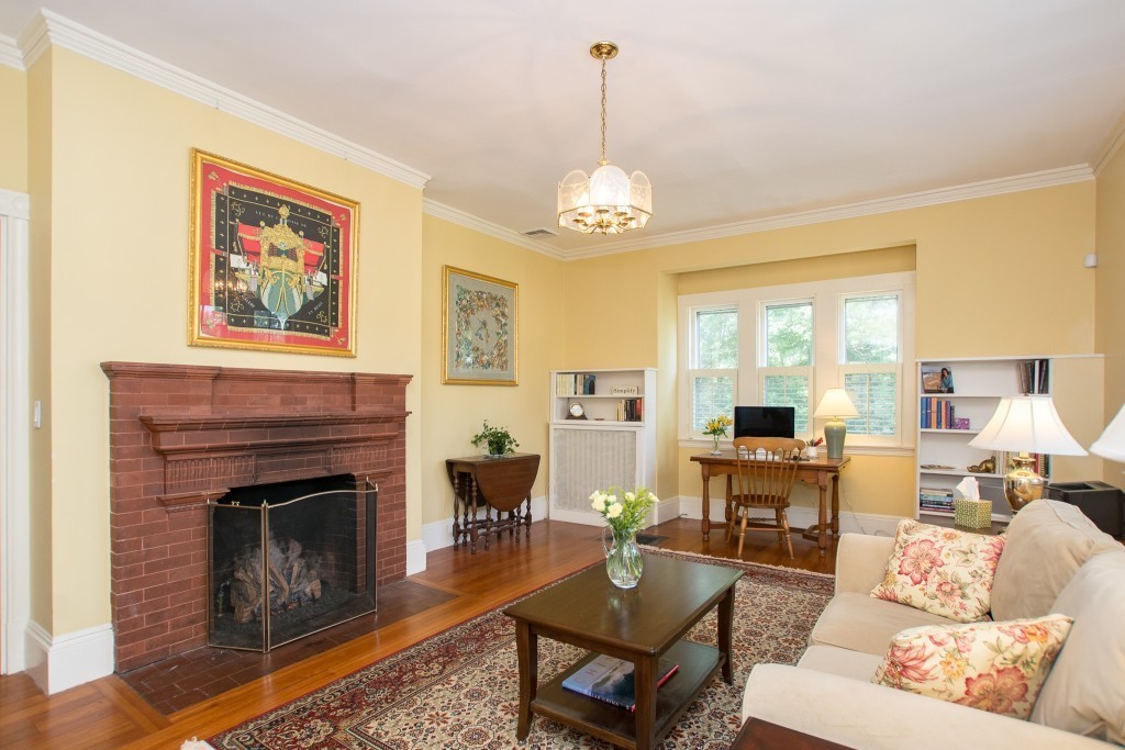 15 West Side Road Milton, MA 02186 - Photo 17 of 28 a living room with furniture chandelier and a fireplace