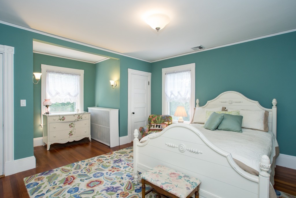 15 West Side Road Milton, MA 02186 - Photo 25 of 28 a bedroom with a bed and a chandelier