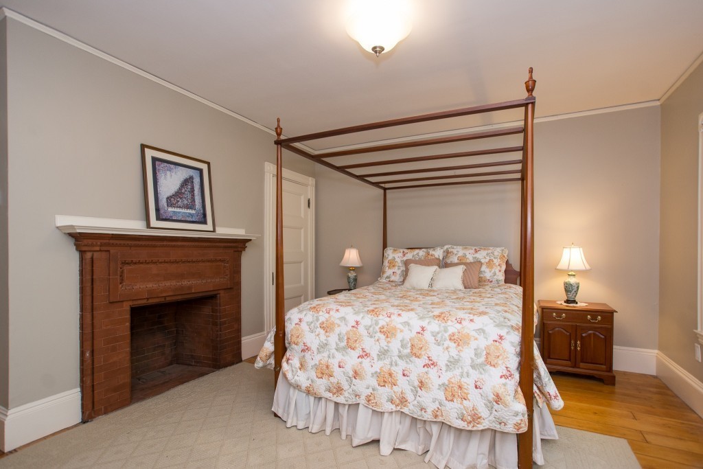 15 West Side Road Milton, MA 02186 - Photo 26 of 28 a bedroom with a bed and a fireplace
