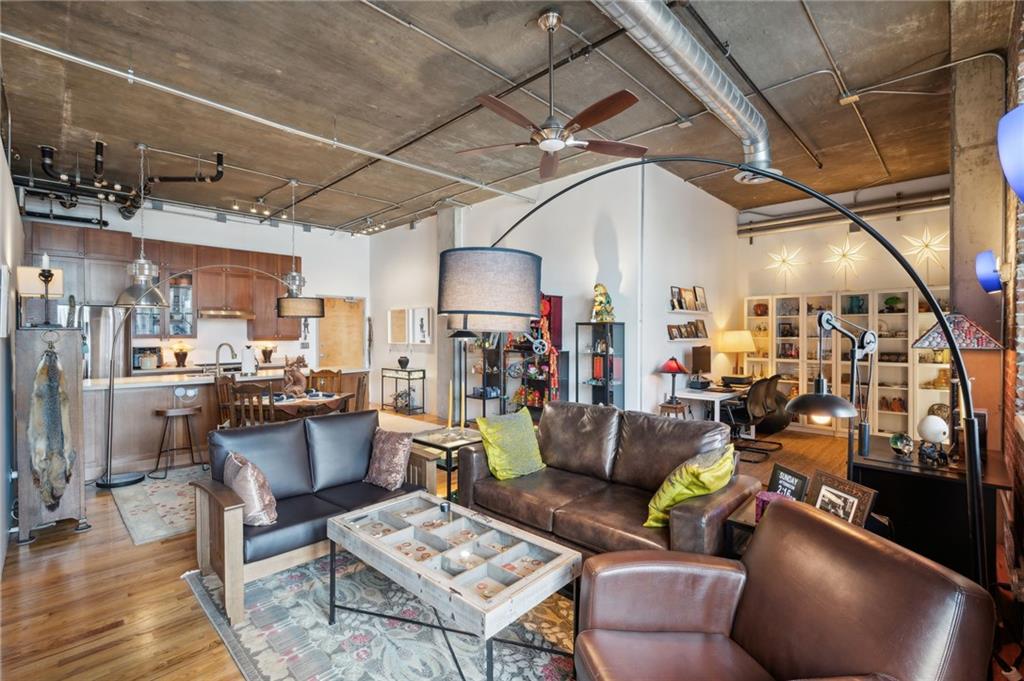 3235 Roswell Road Northeast, Unit 401 Atlanta, GA 30305 - Photo 1 of 1 a living room with lots of furniture and kitchen view
