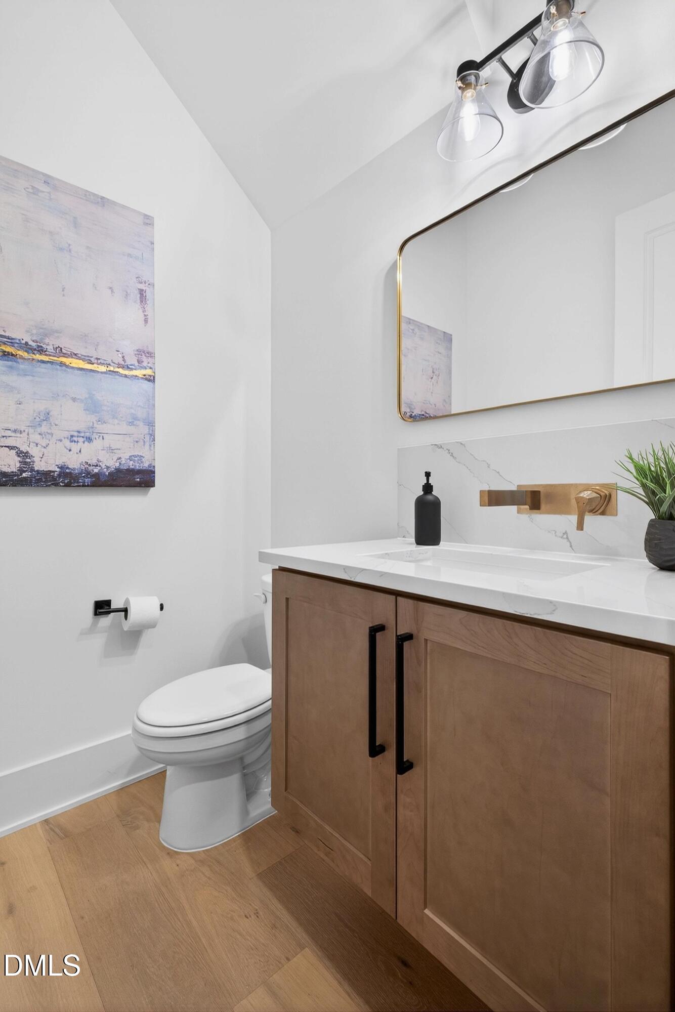 113 Boyd Street Cary, NC 27513 - Photo 24 of 88 a bathroom with a toilet sink and mirror
