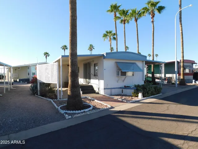 a view of the house with palm tree