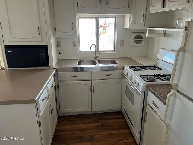 a kitchen with cabinets and appliances