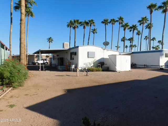 a living room with stainless steel appliances granite countertop furniture and a window