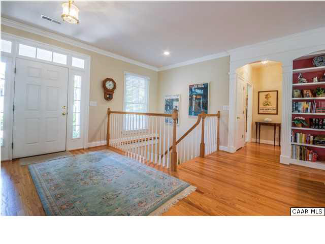 1549 Tavistock Place, Unit R 24 Keswick, VA 22947 - Photo 4 of 31 The eye is drawn to the beautiful wall of French doors that "bring the outdoors in" with lovely views of the woods behind the property. Next to the built- in bookcase, an arched entry leads to a short hall w/study and powder room.