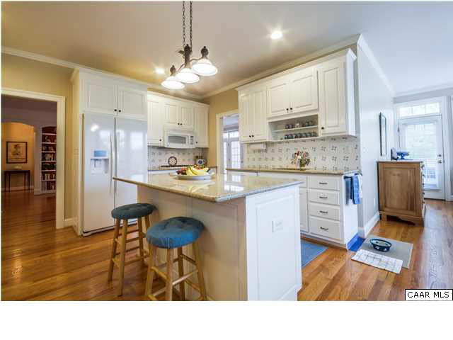 1549 Tavistock Place, Unit R 24 Keswick, VA 22947 - Photo 9 of 31 Elegant without stuffiness. The lovely dining room is trimmed in crown molding & chair rail & has a box bay window that accommodates a sideboard easily. A door provides convenient direct access to the kitchen making setting & serving a breeze.