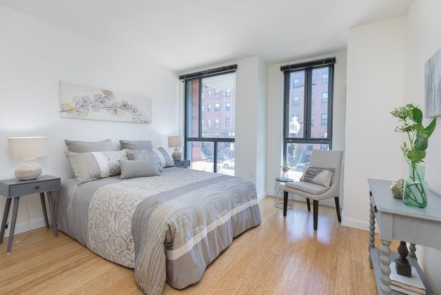 a bed room with a bed and a chair