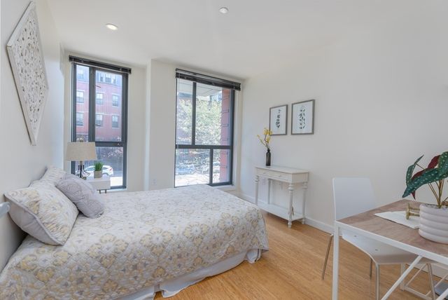 a bedroom with a bed and a table