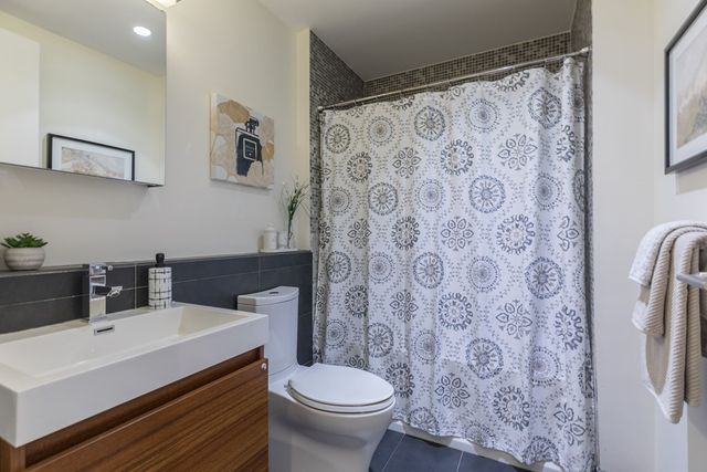 a bathroom with a sink toilet and a mirror