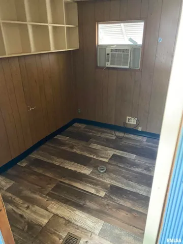 a view of a room with wooden floor and cabinet
