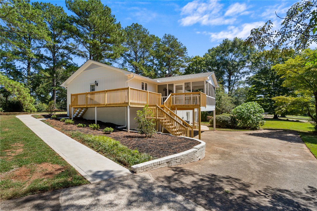 208 Williamsburg Road Anderson, SC 29621 - Photo 48 of 48 An elevated wooden deck and screened porch extend from this wood-sided exterior.