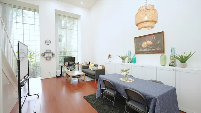 a view of a dining room with furniture window and wooden floor