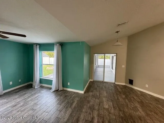 an empty room with closet and windows