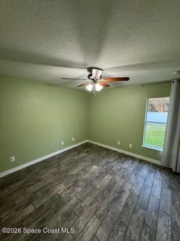 a view of a room with a fan and a window