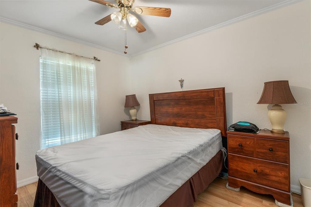 25324 Lychee Court Punta Gorda, FL 33955 - Photo 13 of 30 a bedroom with a bed and a chandelier