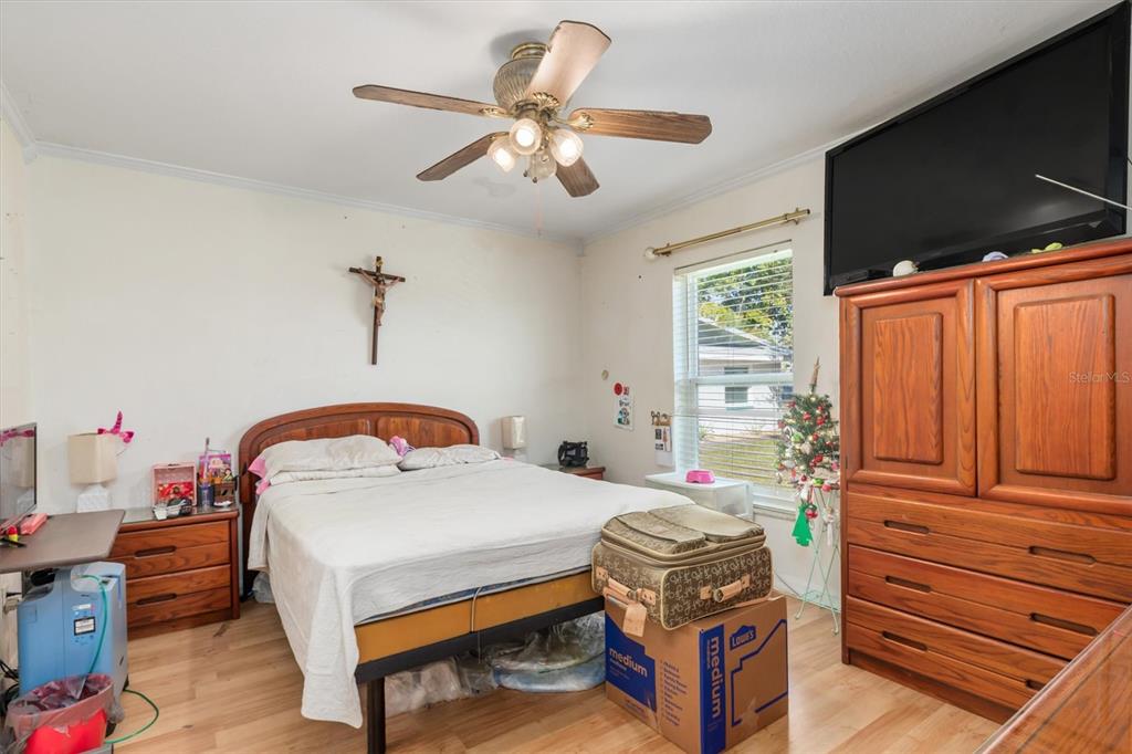 25324 Lychee Court Punta Gorda, FL 33955 - Photo 14 of 30 a bedroom with a bed and wooden floor