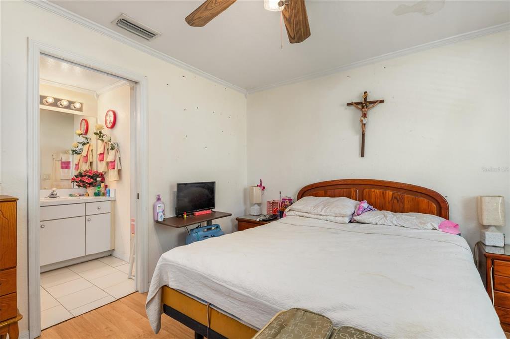 25324 Lychee Court Punta Gorda, FL 33955 - Photo 15 of 30 a bedroom with a bed and a flat screen tv