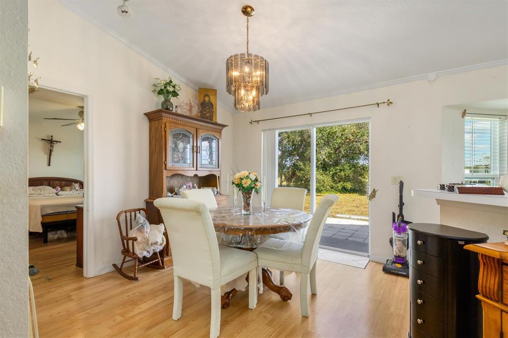25324 Lychee Court Punta Gorda, FL 33955 - Photo 6 of 30 a view of a dining room with furniture wooden floor and a chandelier