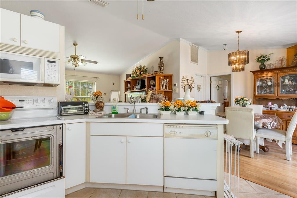 25324 Lychee Court Punta Gorda, FL 33955 - Photo 10 of 30 a kitchen with cabinets and chairs